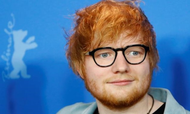 FILE PHOTO: Ed Sheeran poses during a photocall to promote the movie Songwriter at the 68th Berlinale International Film Festival in Berlin, Germany, February 23, 2018. REUTERS/Fabrizio Bensch/File Photo