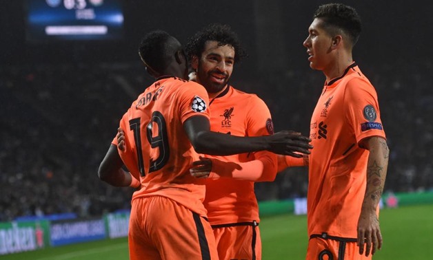 Liverpool's Sadio Mane (L) celebrates with Mohamed Salah and Roberto Firmino (R) after scoring a goal, AFP