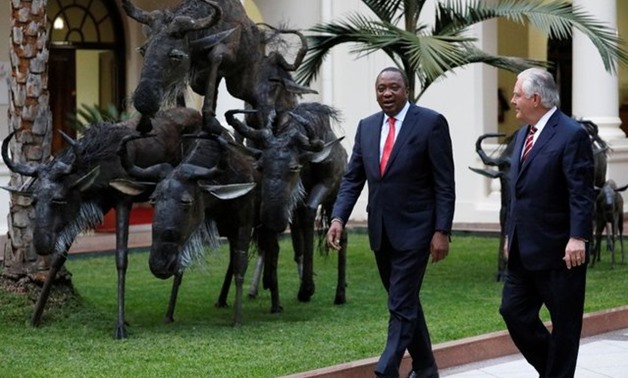 Kenya's President Uhuru Kenyatta walks with U.S. Secretary of State Rex Tillerson after their meeting at the State House in Nairobi, Kenya, March 9, 2018. REUTERS/Jonathan Ernst