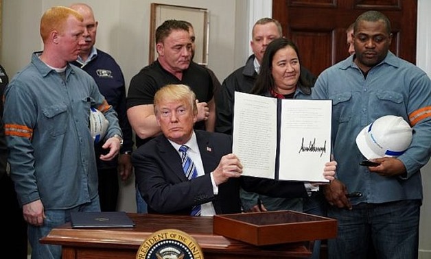US President Donald Trump signs Section 232 Proclamations on Steel and Aluminum Imports in the Oval Office of the White House on March 8, 2018, in Washington, DC. ( AFP PHOTO / Mandel NGAN)
