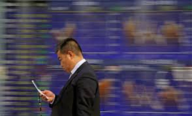  A man walks past an electronic stock quotation board outside a brokerage in Tokyo, Japan, February 9, 2018 -
 REUTERS/Toru Hanai