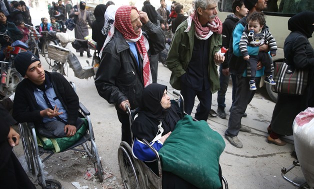 An elderly woman sits in a wheelchair during evacuation from the besieged town of Douma, Eastern Ghouta, in Damascus, Syria March 22, 2018. REUTERS/Bassam Khabieh