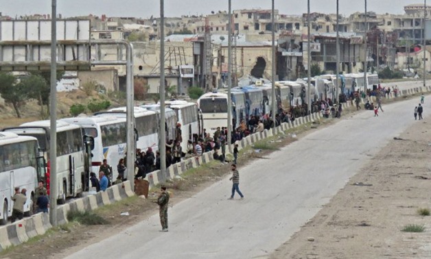 Hundreds of rebel fighters and civilians from Harasta in Syria’s Eastern Ghouta board buses on March 23, 2018 in an evacuation deal as a Russian-backed regime assault comes close to recapturing full control of the region
