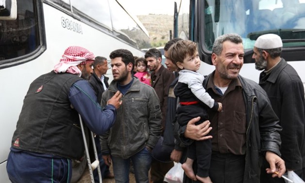 Syrian civilians and rebel fighters arrive in Hama province on March 25, 2018, after being evacuated from Eastern Ghouta following an evacuation deal brokered by regime backer Russia
