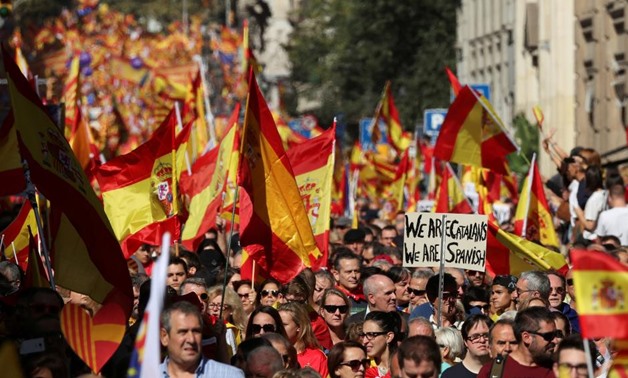 People wave Spanish and Catalan flags as they attend a pro-union demonstration organised by the Catalan Civil Society organisation in Barcelona, Spain, October 8, 2017. REUTERS/Albert Gea
