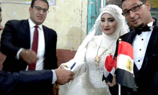 FILE - A married couple in Beni Suef cast their ballots in the Presidential 
