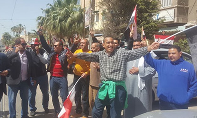 Egyptian men dance outside a polling station in Alexandria after casting their votes - Egypt Today/Hanaa Abo Elez