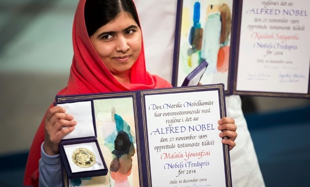 Nobel Peace Prize laureate Malala Yousafzai displays her medal and diploma during the 2014 Nobel Peace Prize awards ceremony in Oslo - AFP/File / Odd Andersen