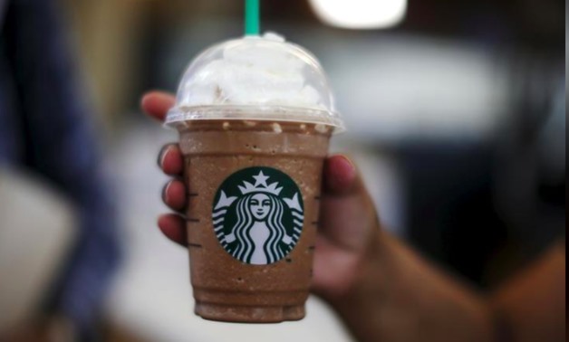 FILE PHOTO - A woman holds a Frappuccino at a Starbucks store inside the Tom Bradley terminal at LAX airport in Los Angeles, California, United States, October 27, 2015. REUTERS/Lucy Nicholson