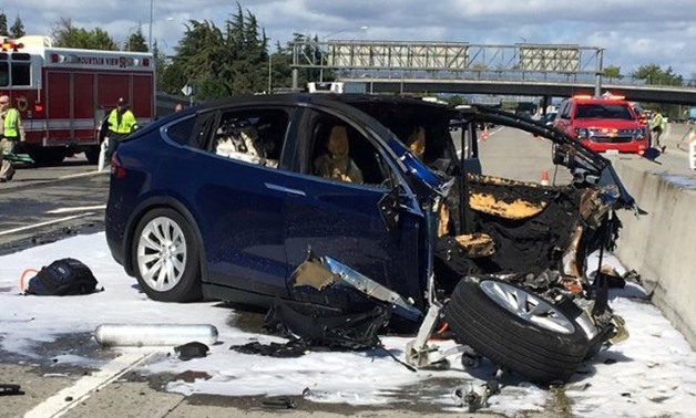 FILE PHOTO: Rescue workers attend the scene where a Tesla electric SUV crashed into a barrier on U.S. Highway 101 in Mountain View, California, March 25, 2018. KTVU FOX 2/via REUTERS