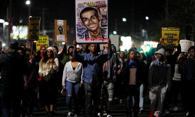 Demonstrators march to protest the police shooting of Stephon Clark, in Sacramento, California. REUTERS/Bob Strong
