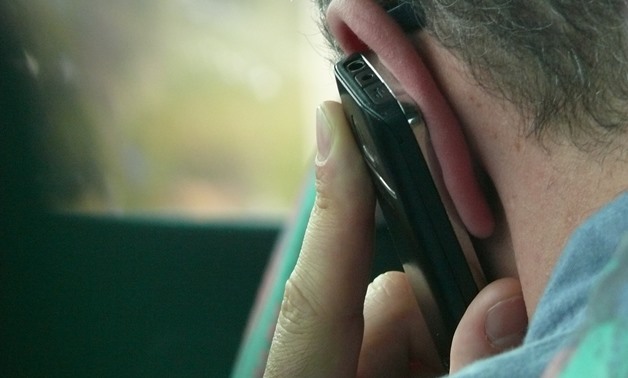 FILE – A man holding a mobile phone to his ear/pxhere