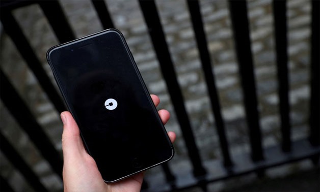 The Uber logo is seen on mobile telephone in London, Britain, September 25, 2017. REUTERS/Hannah McKay/File Photo