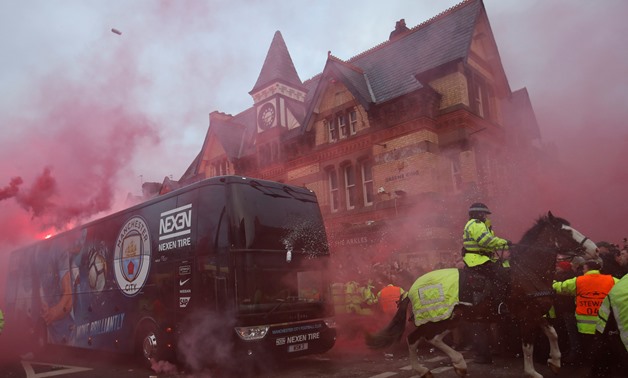 Soccer Football - Champions League Quarter Final First Leg - Liverpool vs Manchester City - Anfield, Liverpool, Britain - April 4, 2018 Liverpool fans set off flares and throw missiles at the Manchester City team bus outside the stadium before the match A