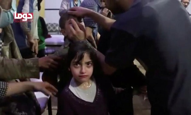 A girl looks on following alleged chemical weapons attack, in what is said to be Douma, Syria in this still image from video obtained by Reuters on April 8, 2018. White Helmets/Reuters TV via REUTERS
