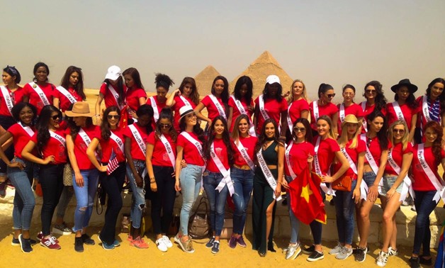 Competitors of Miss Eco International pageant are posing for a photo in front of Giza Pyramids on Wednesday April 18, 2018