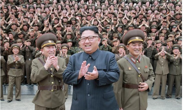 North Korean leader Kim Jong Un claps with military officers at the Command of the Strategic Force of the Korean People's Army (KPA) in an unknown location in North Korea in this undated photo released by North Korea's Korean Central News Agency (KCNA) on