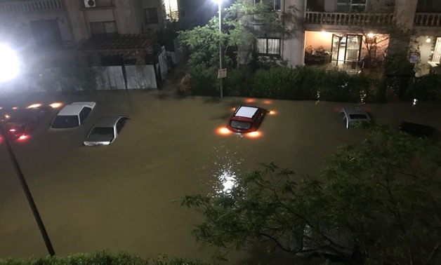 Vehicles submerged in the flooded New Cairo streets in which water levels rose over one meter after torrential rain hit hard several parts of Cairo and Giza on Tuesday, April 25, 2018 – Egypt Today