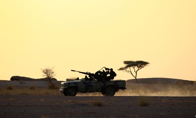 FILE - The Polisario Front soldiers drive a pick-up truck mounted with an anti-aircraft weapon during sunset in Bir Lahlou, Western Sahara, Sept. 9, 2016.
