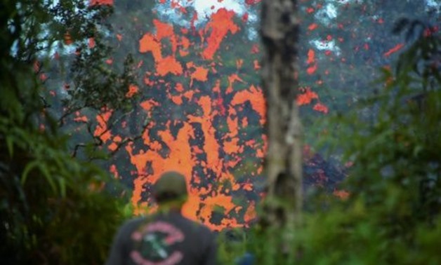 Lava spits from a fissure in the Leilani Estates subdivision on Hawaii's Big Island after earthquakes prompted the Kilauea volcano to erupt
