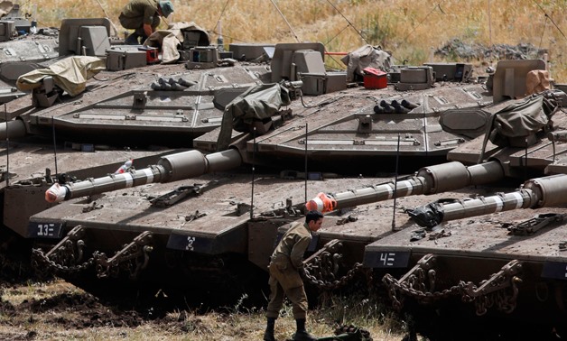  Israeli Merkava tanks and soldiers are seen in a deployment area near the Syrian border in the Israel-annexed Golan Heights on May 10, 2018- AFP