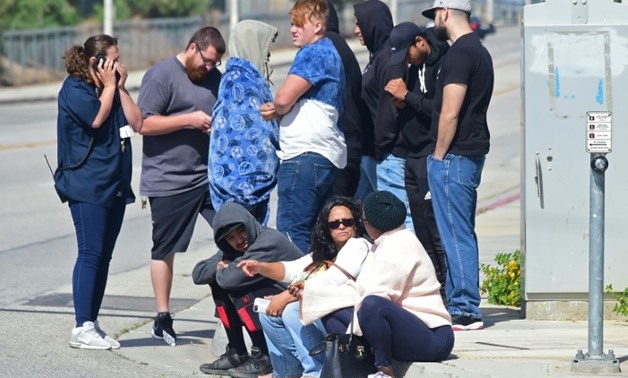 People wait at an intersection following reports of a shooting at nearby Highland High School in Palmdale, California
