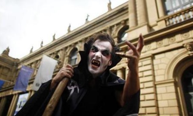 A demonstrator dressed as a vampire gestures in front of Frankfurt's stock exchange, September 15, 2010. REUTERS/Kai Pfaffenbach