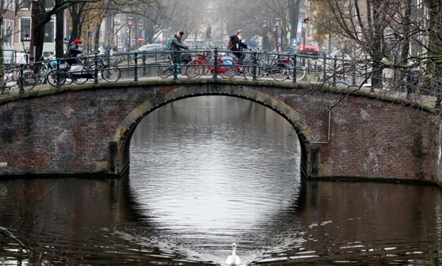 FILE PHOTO: Cyclists ride on a bridge in central Amsterdam, Netherlands, December 1, 2017. REUTERS/Yves Herman/File Photo