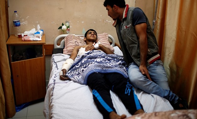An injured Palestinian lies on a bed at a hospital in Gaza City May 15, 2018. REUTERS/Mohammed Salem
