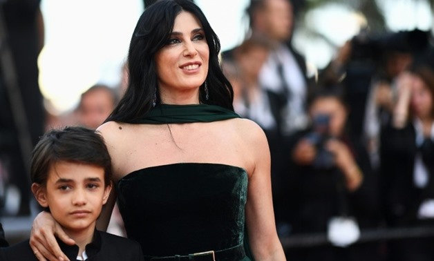 13-year-old Syrian refugee Zain Al Rafeea and Lebanese director Nadine Labaki on the red carpet / AFP/ Anne-Christine POUJOULAT