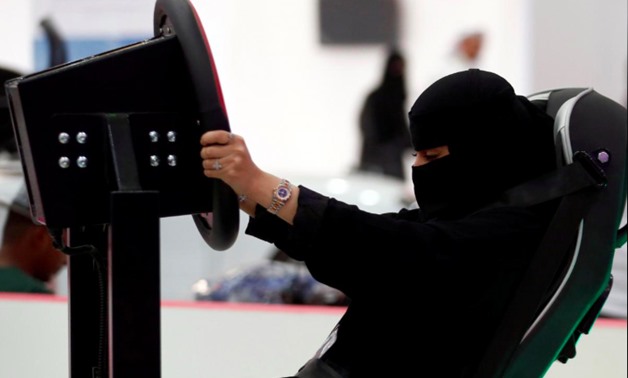 A Saudi woman tries a car simulator during women car show in Riyadh, Saudi Arabia May 13, 2018. REUTERS/Faisal Al Nasser