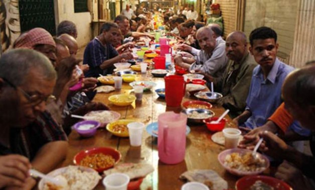 Men in Cairo break their fast with food given as charity, on the first day of Ramadan (Photo: Reuters)
