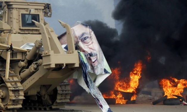A torn poster of deposed Egyptian President Mohamed Morsi is caught on a military vehicle as riot police clear the area of his supporters at Rabaa Adawiya square, where the protesters had been camping, in Cairo. At least 95 Egyptians were killed in ongoin