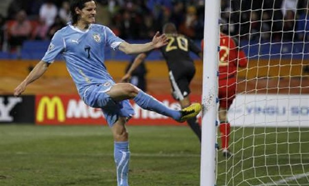 Uruguay's Edinson Cavani kicks the goal post after a missed scoring opportunity during the 2010 World Cup third place playoff soccer match against Germany in Port Elizabeth July 10, 2010. REUTERS/Carlos Barria/Files