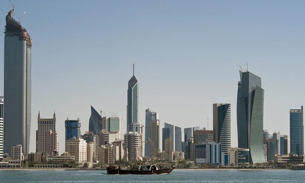 FILE PHOTO: A fishing boat passes in front of the Kuwait City skyline September 11, 2010. REUTERS/Stephanie McGehee