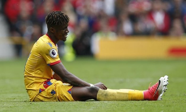 Crystal Palace's Wilfried Zaha lies injured. Reuters / Andrew Yates 