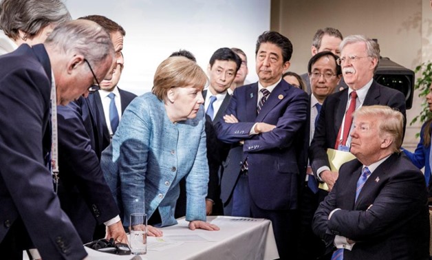 FILE PHOTO: German Chancellor Angela Merkel speaks to U.S. President Donald Trump during the second day of the G7 meeting in Charlevoix city of La Malbaie, Quebec, Canada, June 9, 2018. Bundesregierung/Jesco Denzel/Handout via REUTERS
