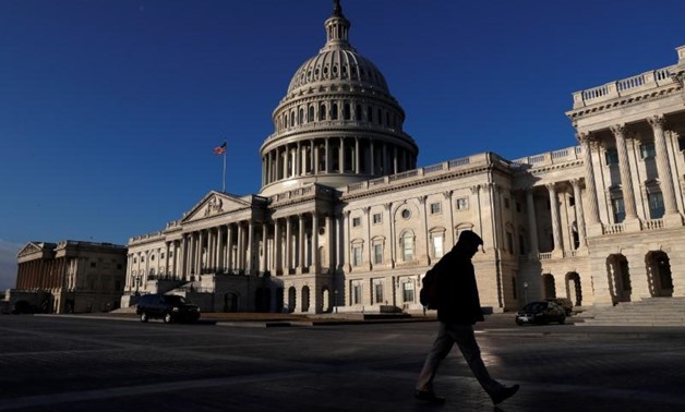 People walk by the U.S. Capitol building in Washington, U.S., February 8, 2018. REUTERS/ Leah Millis

