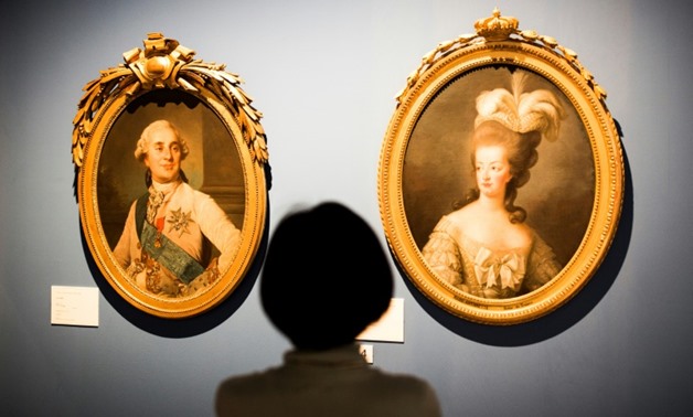 File photo of portraits of King of France, Louis XVI, and his Queen Marie Antoinette. Jewels that once belonged to the queen are due to go on sale in November-AFP/File / BEHROUZ MEHRI

