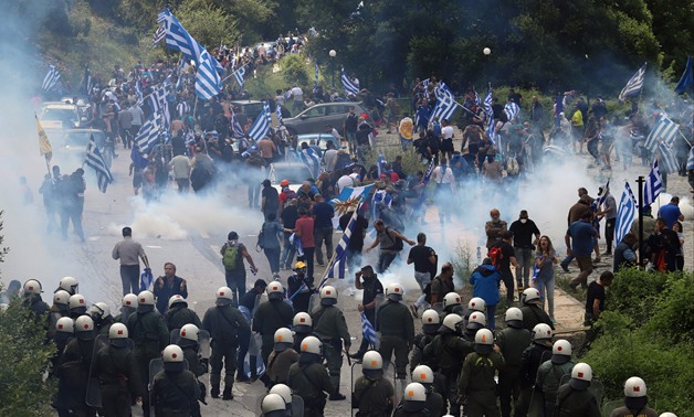 Protestors holding Greek flags clash with riot police during a protest at the village of Pisoderi near the border with Macedonia in northern Greece on July 17, 2018 as the foreign ministers of Greece and Macedonia signed a historic preliminary accord on r