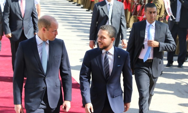 Prince William (L) is greeted at Amman's Marka military airport by Crown Prince Hussein bin Abdullah on June 24, 2018 - AFP