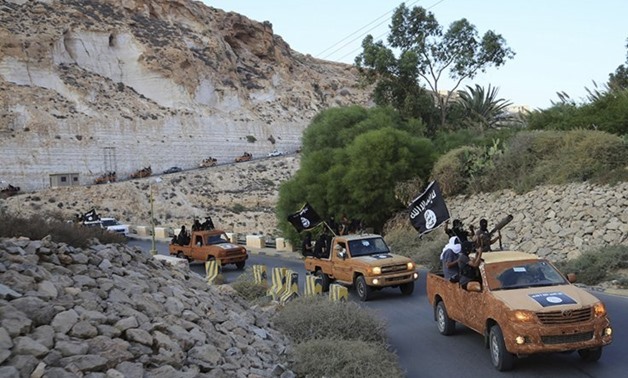 An armed motorcade belonging to members of Derna's Islamic Youth Shura Council, which has pledged allegiance to ISIS, drive along a road in eastern Libya on October 3, 2014 – REUTERS