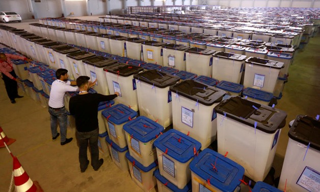 FILE PHOTO: Employees of the Iraqi Independent High Electoral Commission inspect ballot - Reuters
