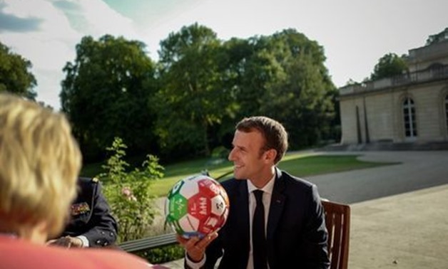 French President Emmanuel Macron holds a soccer ball offered by Norway's Prime Minister Erna Solberg during a bi-lateral meeting at the Elysee Palace, in Paris, France July 6, 2018. Kamil Zihnioglu/Pool via Reuters
