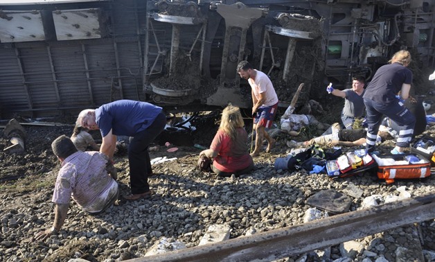 People receive help from medical personnel after a train came off the rails due to heavy rain and a landslide on to the tracks near Corlu in Tekirdag province, Turkey, July 8, 2018. Dogan News Agency via REUTERS