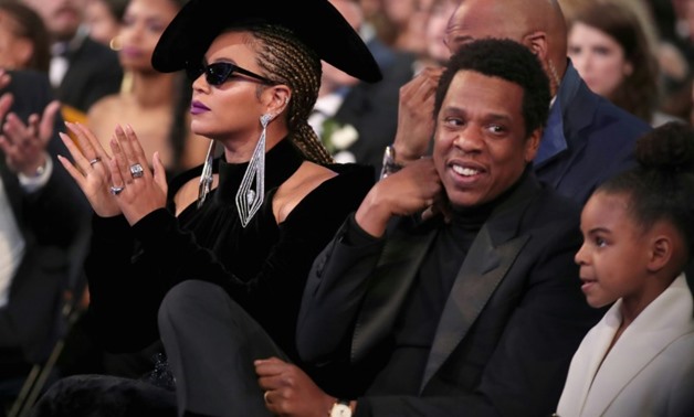 Beyonce and her husband Jay Z, pictured with their daughter Blue Ivy Carter, will headline an anti-poverty music festival in Johannesburg, South Africa