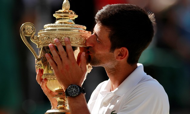 Tennis - Wimbledon - All England Lawn Tennis and Croquet Club, London, Britain - July 15, 2018 Serbia's Novak Djokovic celebrates with the trophy after winning the men's singles final against South Africa's Kevin Anderson. REUTERS/Andrew Couldridge TPX IM