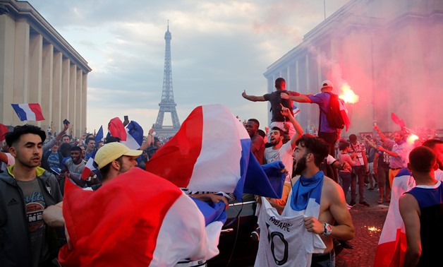 France fans watch France v Croatia - Paris, France - July 15, 2018 Fans celebrate in front of the Eiffel Tower after France win the World Cup REUTERS/Jean-Paul Pelissier