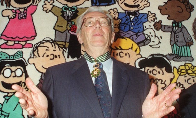 Charles Schulz, creator of the legendary Peanuts comic strip, seen here in 1990 at the Paris Museum of Decorative Arts; Franklin is in the upper right of the frame.