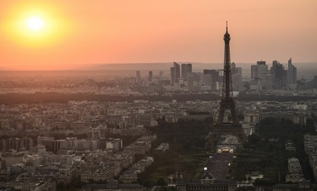 File- This file photo taken on July 14, 2018 from the panoramic observatory of the Montparnasse Tower (Tour Montparnasse) shows the sunset over Paris and the Eiffel Tower. AFP / Lucas BARIOULET